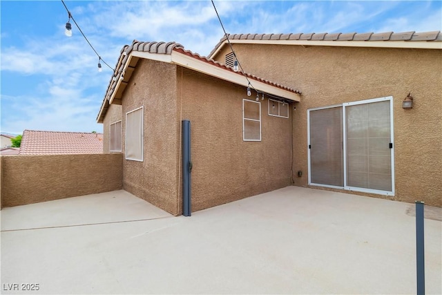 5001 Pounding Surf Ave, Las Vegas, NV 89131 - back of house featuring stucco siding, a tiled roof, and a patio area