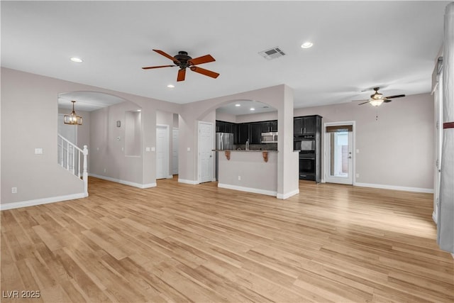 5001 Pounding Surf Ave, Las Vegas, NV 89131 - unfurnished living room featuring ceiling fan, light wood finished floors, recessed lighting, and arched walkways
