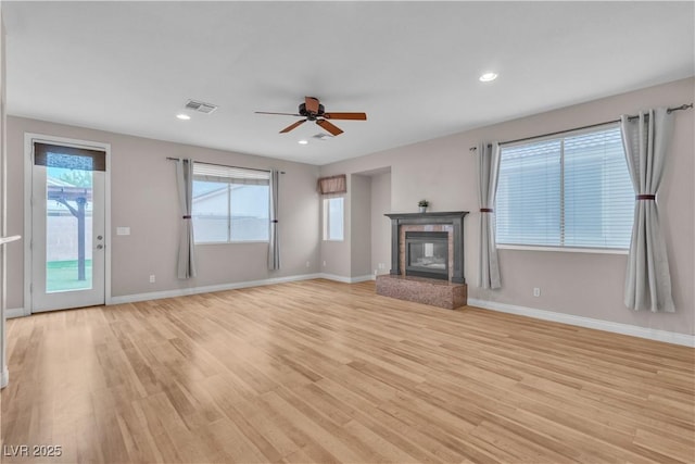5001 Pounding Surf Ave, Las Vegas, NV 89131 - unfurnished living room featuring light wood-type flooring, ceiling fan, a glass covered fireplace, and recessed lighting