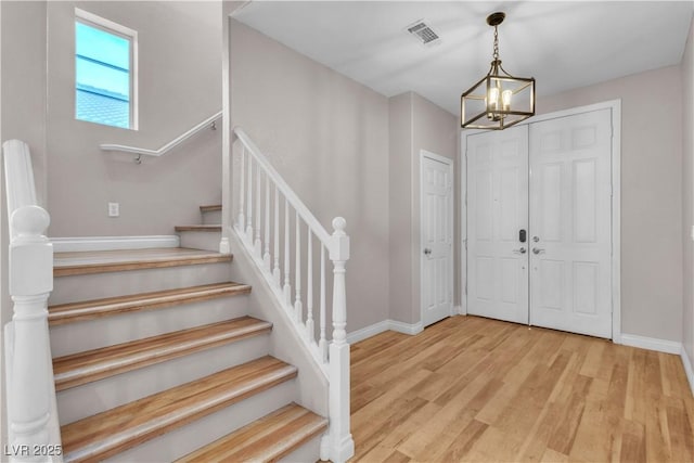 5001 Pounding Surf Ave, Las Vegas, NV 89131 - entrance foyer featuring a chandelier, wood finished floors, and stairs