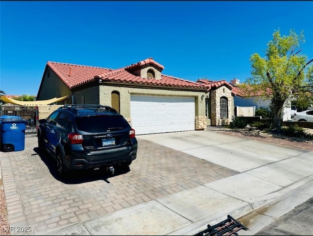 4216 Famoso Dr, North Las Vegas, NV 89032 - mediterranean / spanish house featuring a tiled roof, driveway, stucco siding, a garage, and stone siding
