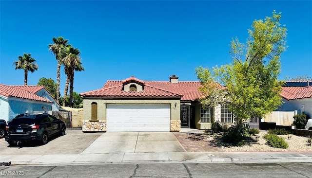 4216 Famoso Dr, North Las Vegas, NV 89032 - mediterranean / spanish-style house with a tile roof, an attached garage, stucco siding, a chimney, and driveway