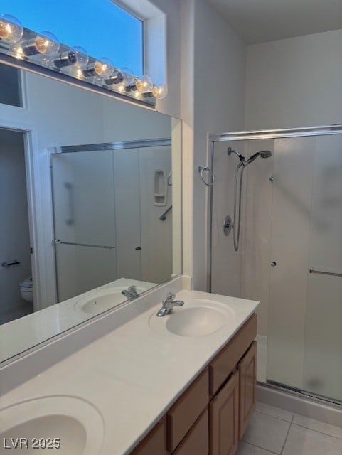 3013 Abercorn Dr, Las Vegas, NV 89134 - bathroom featuring a shower stall, double vanity, and tile patterned flooring