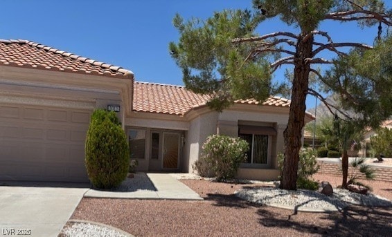 3013 Abercorn Dr, Las Vegas, NV 89134 - mediterranean / spanish house featuring a tile roof, an attached garage, stucco siding, and driveway
