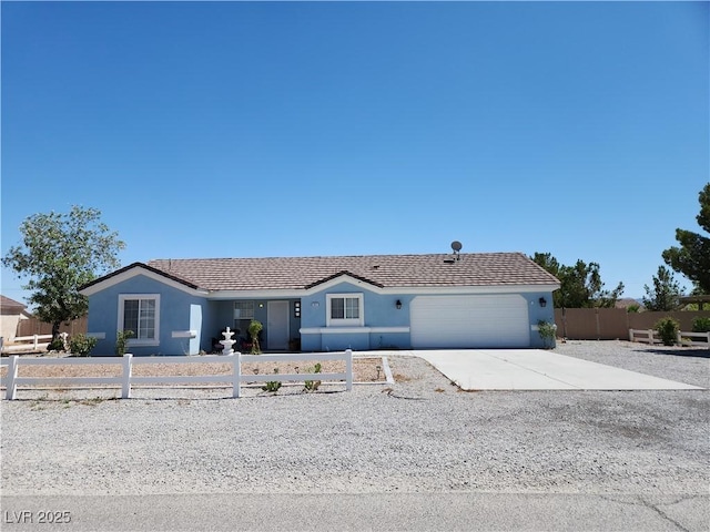 161 Diamond Bar Rd, Pahrump, NV 89048 - single story home with a fenced front yard, a garage, stucco siding, and driveway