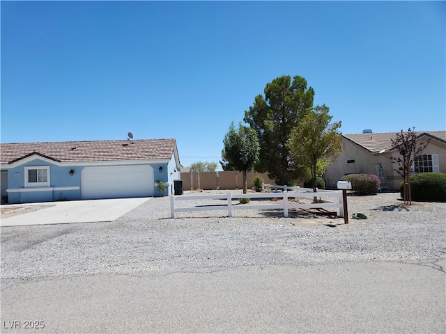 161 Diamond Bar Rd, Pahrump, NV 89048 - view of front facade featuring an attached garage, stucco siding, concrete driveway, and a tiled roof