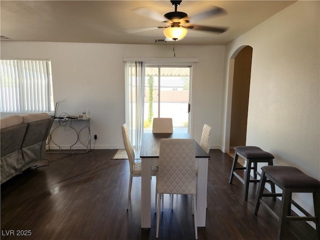 161 Diamond Bar Rd, Pahrump, NV 89048 - dining space featuring arched walkways, dark wood-type flooring, and a ceiling fan