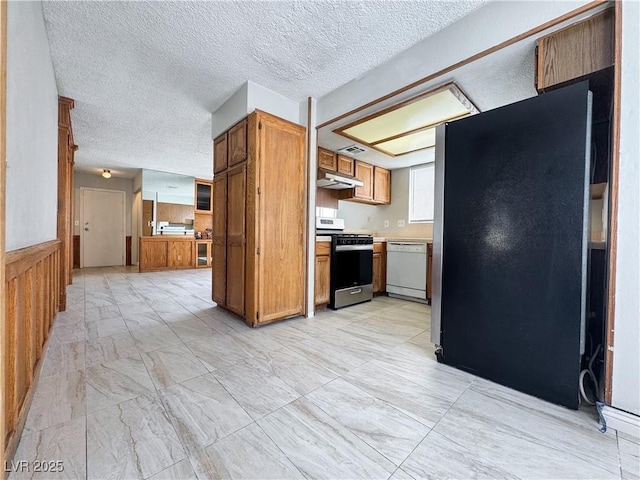 6437 Peachwood Rd, Las Vegas, NV 89108 - kitchen featuring stainless steel range with gas stovetop, white dishwasher, freestanding refrigerator, under cabinet range hood, and light countertops
