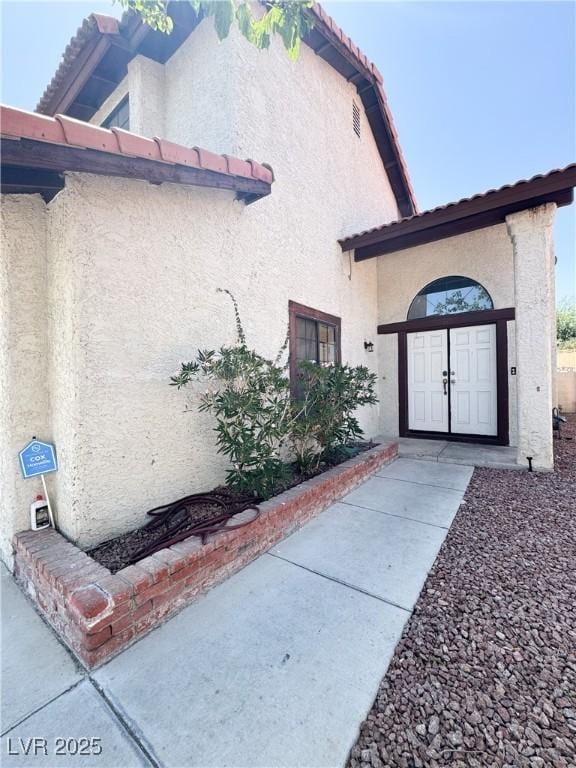 6437 Peachwood Rd, Las Vegas, NV 89108 - view of side of home with stucco siding and a tile roof