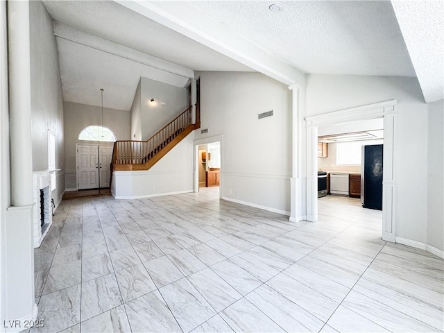 6437 Peachwood Rd, Las Vegas, NV 89108 - unfurnished living room with stairs, high vaulted ceiling, a textured ceiling, and beam ceiling