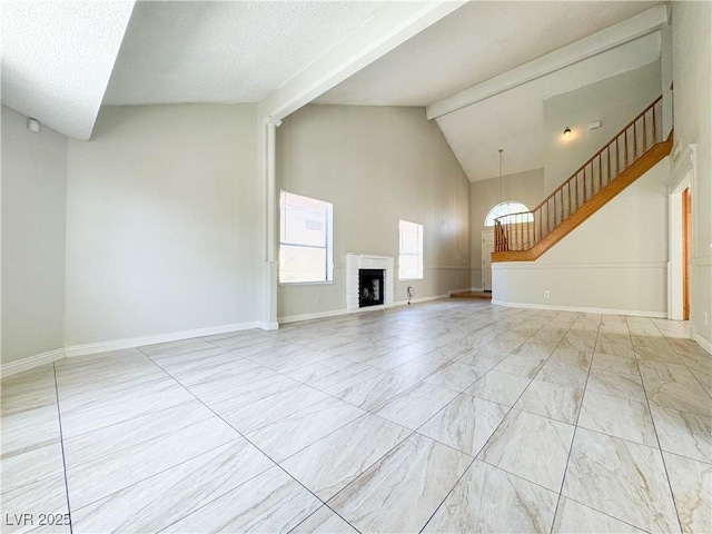 6437 Peachwood Rd, Las Vegas, NV 89108 - unfurnished living room with high vaulted ceiling, beamed ceiling, a fireplace, and stairway