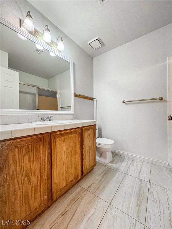 6437 Peachwood Rd, Las Vegas, NV 89108 - full bathroom featuring vanity, a shower, and marble look tile flooring