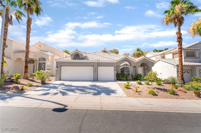 9332 Sienna Vista Dr, Las Vegas, NV 89117 - mediterranean / spanish home with an attached garage, stucco siding, driveway, and a tile roof