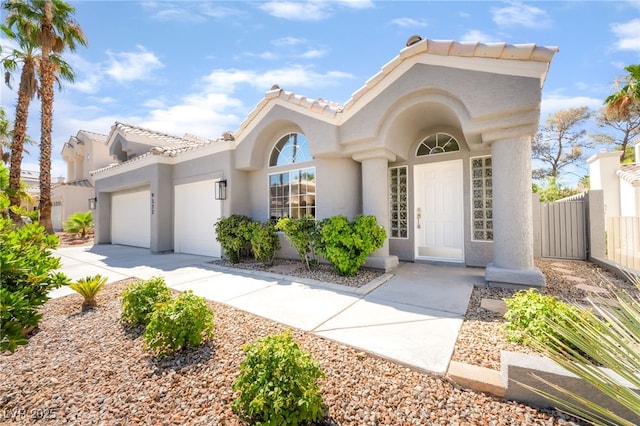 9332 Sienna Vista Dr, Las Vegas, NV 89117 - view of front facade featuring stucco siding, a garage, concrete driveway, and a tiled roof