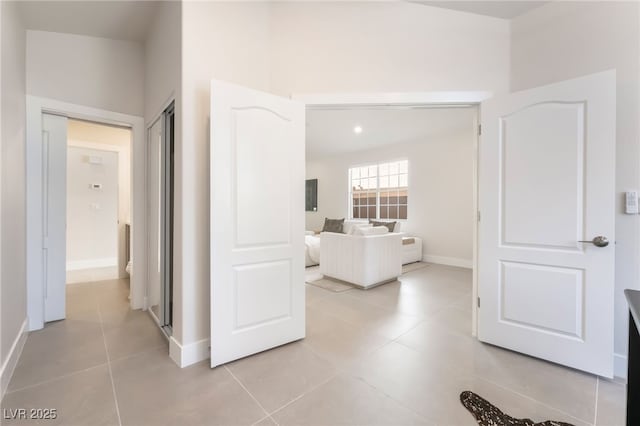 9332 Sienna Vista Dr, Las Vegas, NV 89117 - hallway featuring light tile patterned flooring and baseboards