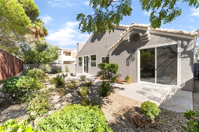 9332 Sienna Vista Dr, Las Vegas, NV 89117 - rear view of house with stucco siding, a patio, a fenced backyard, and a tile roof