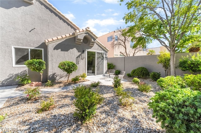 9332 Sienna Vista Dr, Las Vegas, NV 89117 - back of property featuring stucco siding, a tile roof, and a patio area