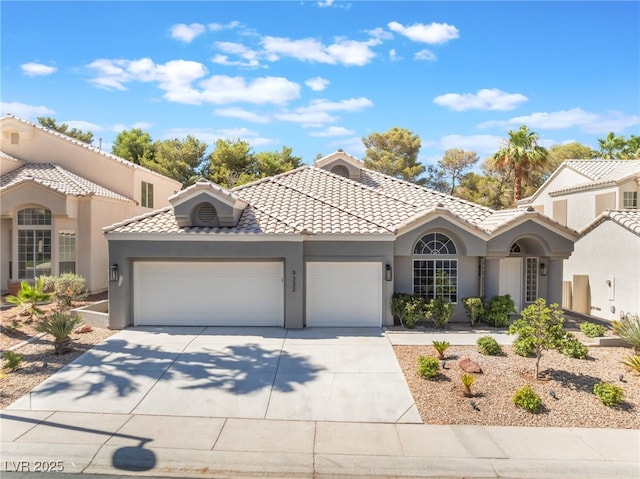 9332 Sienna Vista Dr, Las Vegas, NV 89117 - mediterranean / spanish home featuring a garage, stucco siding, concrete driveway, and a tiled roof