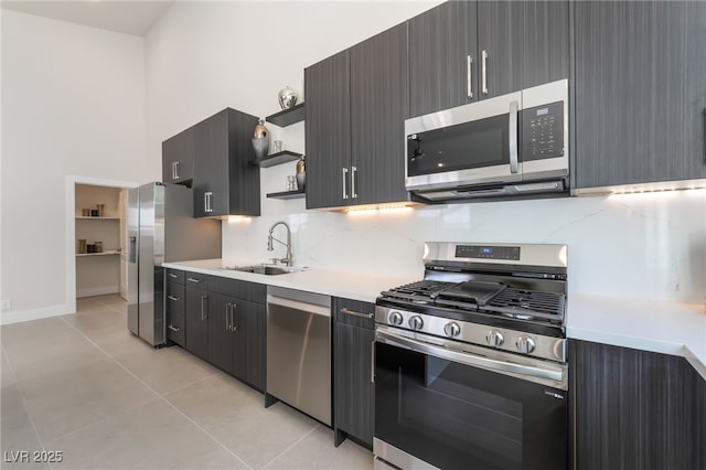 9332 Sienna Vista Dr, Las Vegas, NV 89117 - kitchen featuring appliances with stainless steel finishes, open shelves, light tile patterned flooring, light countertops, and decorative backsplash