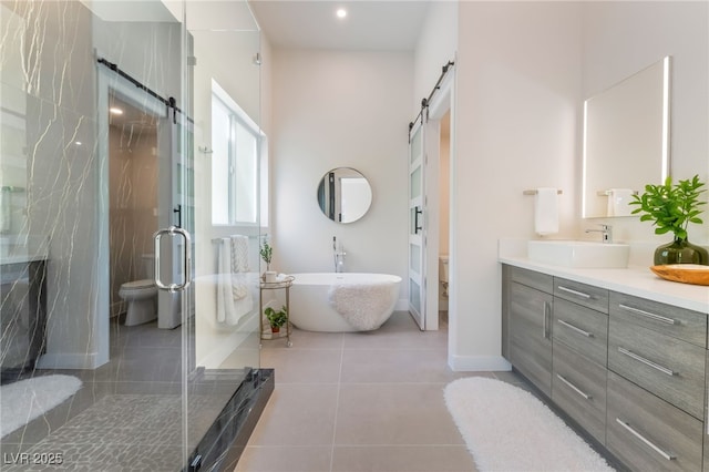 9332 Sienna Vista Dr, Las Vegas, NV 89117 - full bathroom featuring vanity, a freestanding tub, a stall shower, and tile patterned flooring