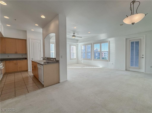 38 E Serene Ave Unit 402, Las Vegas, NV 89123 - kitchen with ceiling fan, open floor plan, dark countertops, arched walkways, and white dishwasher