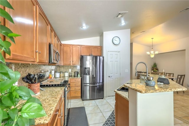 3032 Prairie Princess Ave, North Las Vegas, NV 89081 - kitchen featuring stainless steel appliances, lofted ceiling, tasteful backsplash, light tile patterned floors, and a kitchen island with sink