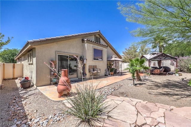 3032 Prairie Princess Ave, North Las Vegas, NV 89081 - rear view of house with a gazebo, stucco siding, a tile roof, a fenced backyard, and a patio area