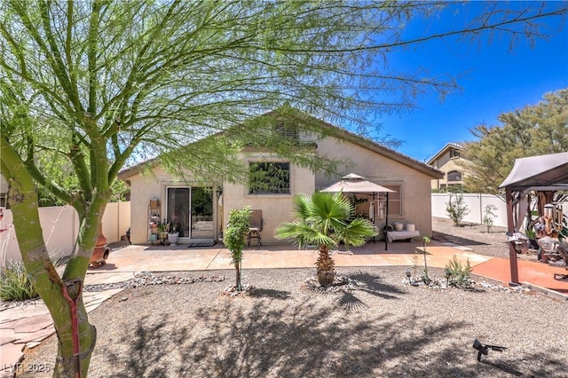 3032 Prairie Princess Ave, North Las Vegas, NV 89081 - back of property with a gazebo, stucco siding, a patio area, and a fenced backyard