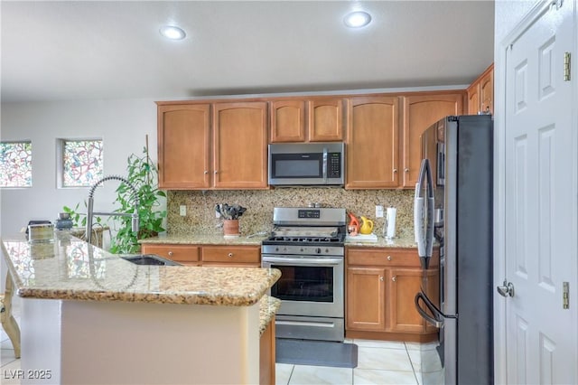 3032 Prairie Princess Ave, North Las Vegas, NV 89081 - kitchen with stainless steel appliances, backsplash, light stone counters, light tile patterned floors, and recessed lighting