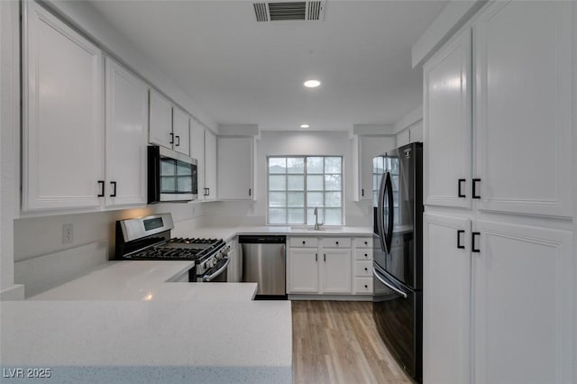 5201 S Torrey Pines Dr Unit 1184, Las Vegas, NV 89118 - kitchen featuring appliances with stainless steel finishes, light countertops, light wood-style flooring, recessed lighting, and white cabinetry