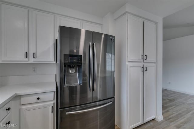 5201 S Torrey Pines Dr Unit 1184, Las Vegas, NV 89118 - kitchen with stainless steel fridge with ice dispenser, white cabinetry, light countertops, and light wood-style flooring