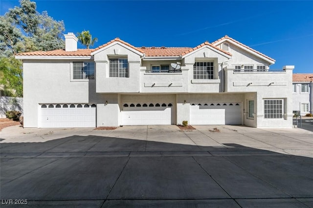 5201 S Torrey Pines Dr Unit 1184, Las Vegas, NV 89118 - mediterranean / spanish-style house featuring stucco siding, driveway, a garage, a chimney, and a tiled roof