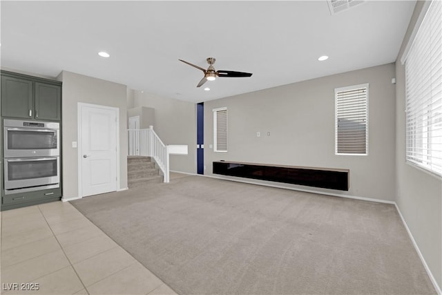 8969 Rice Peak St, Las Vegas, NV 89148 - unfurnished living room featuring stairway, ceiling fan, light carpet, light tile patterned floors, and recessed lighting