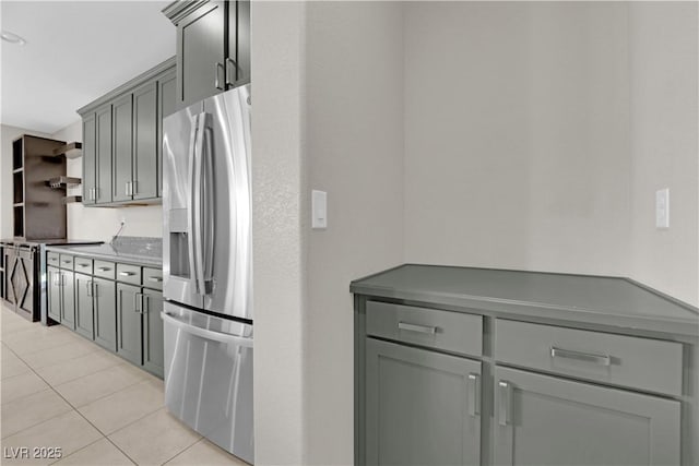 8969 Rice Peak St, Las Vegas, NV 89148 - kitchen with stainless steel appliances, light tile patterned floors, open shelves, wall chimney exhaust hood, and gray cabinetry