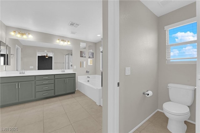 8969 Rice Peak St, Las Vegas, NV 89148 - bathroom with a garden tub, double vanity, and tile patterned floors