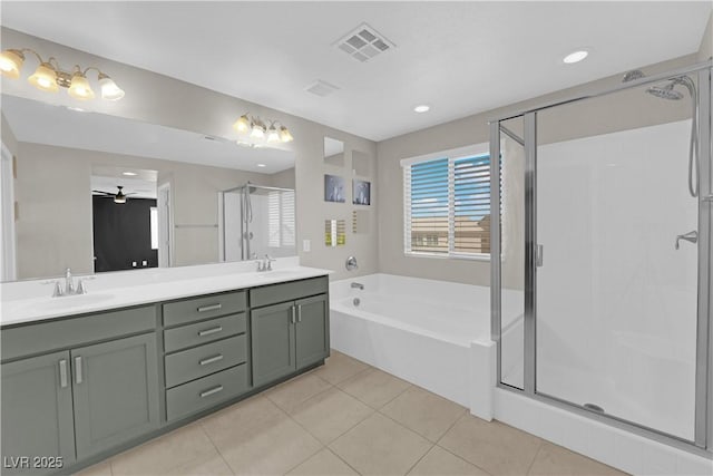 8969 Rice Peak St, Las Vegas, NV 89148 - bathroom with a bath, a stall shower, double vanity, ceiling fan, and tile patterned floors