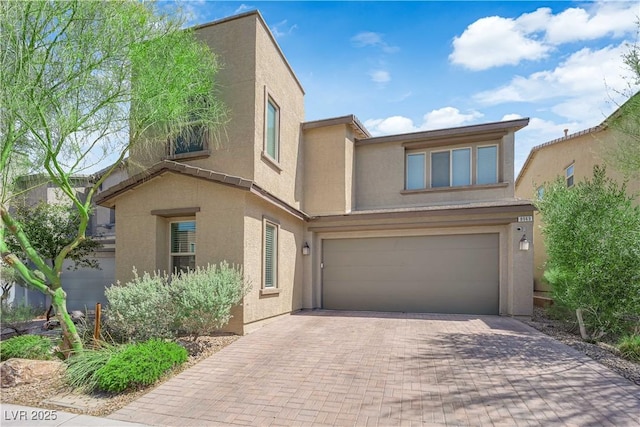 8969 Rice Peak St, Las Vegas, NV 89148 - view of front facade with stucco siding, decorative driveway, and a garage