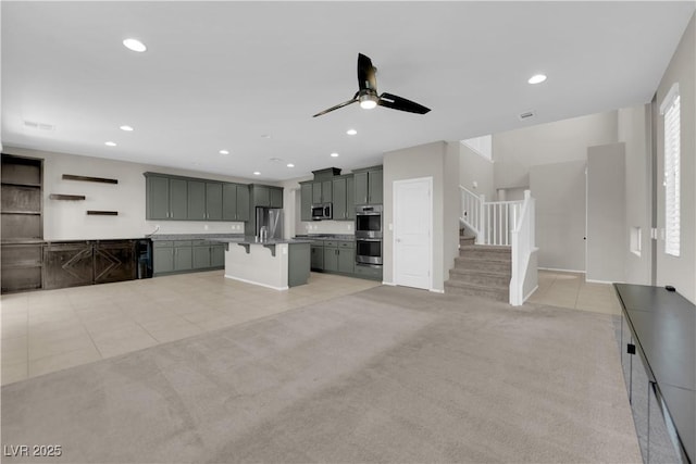 8969 Rice Peak St, Las Vegas, NV 89148 - unfurnished living room featuring a ceiling fan, light tile patterned flooring, stairway, light carpet, and recessed lighting