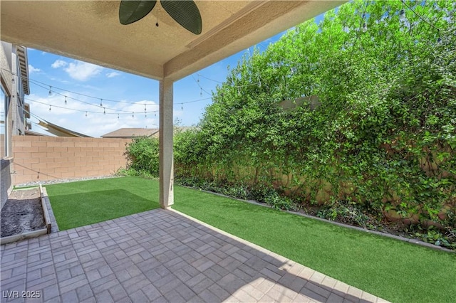 8969 Rice Peak St, Las Vegas, NV 89148 - fenced backyard with a ceiling fan and a patio