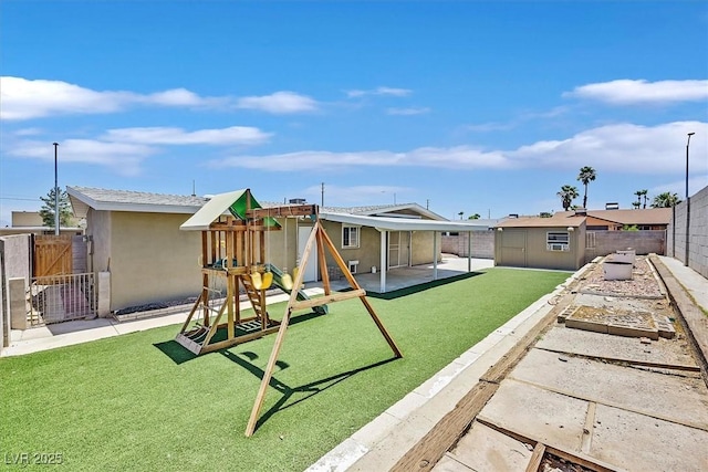 216 Lorenzi St, Las Vegas, NV 89107 - fenced backyard with a playground, a garden, and a gate
