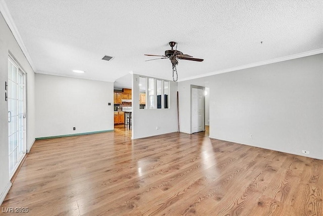 216 Lorenzi St, Las Vegas, NV 89107 - unfurnished living room featuring crown molding, ceiling fan, a textured ceiling, and light wood-style flooring