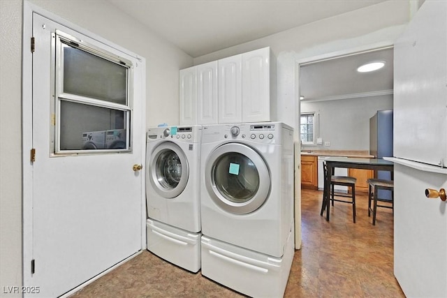 216 Lorenzi St, Las Vegas, NV 89107 - laundry room featuring washer and dryer, cabinet space, and crown molding