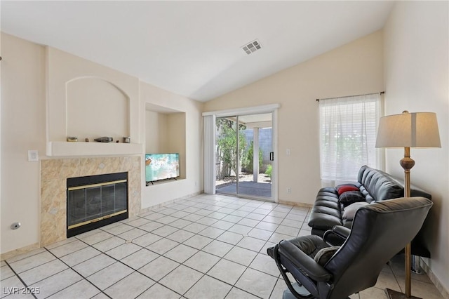 9362 Baltinglass St, Las Vegas, NV 89123 - living room featuring lofted ceiling, a tile fireplace, and light tile patterned flooring
