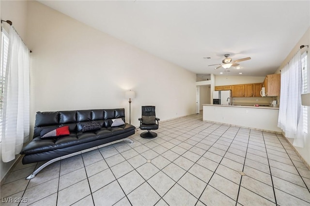 9362 Baltinglass St, Las Vegas, NV 89123 - living room with ceiling fan, light tile patterned floors, and vaulted ceiling