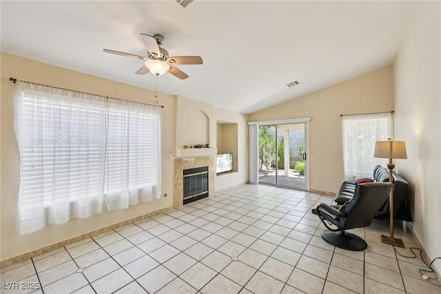 9362 Baltinglass St, Las Vegas, NV 89123 - living room with ceiling fan, vaulted ceiling, a fireplace, and light tile patterned floors