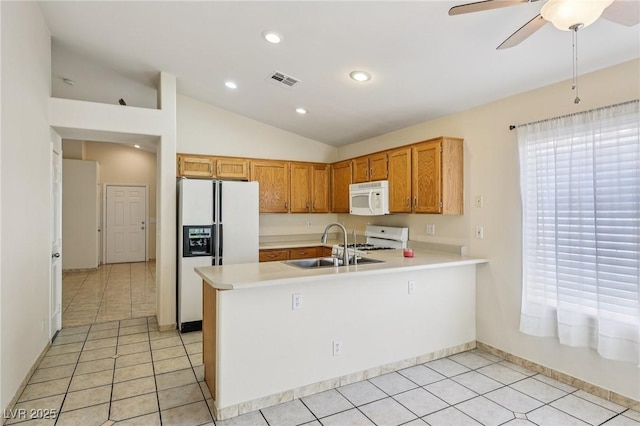 9362 Baltinglass St, Las Vegas, NV 89123 - kitchen featuring white appliances, light countertops, a peninsula, vaulted ceiling, and ceiling fan