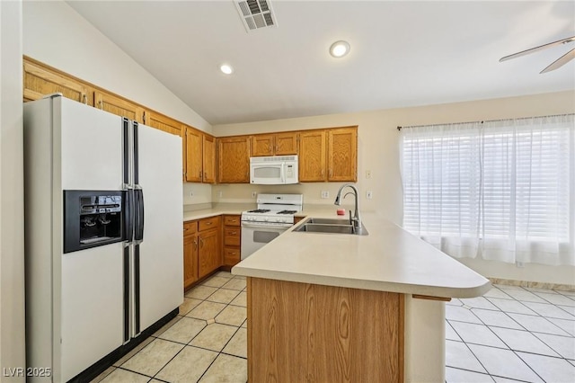 9362 Baltinglass St, Las Vegas, NV 89123 - kitchen featuring white appliances, a peninsula, light countertops, light tile patterned floors, and lofted ceiling
