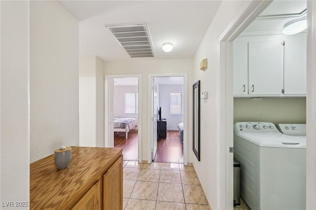 9362 Baltinglass St, Las Vegas, NV 89123 - laundry room with cabinet space, washer and clothes dryer, and light tile patterned floors
