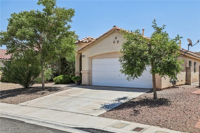 9362 Baltinglass St, Las Vegas, NV 89123 - view of front of house with driveway, stucco siding, an attached garage, and a tiled roof