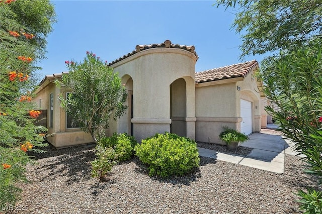 9362 Baltinglass St, Las Vegas, NV 89123 - mediterranean / spanish home featuring an attached garage, a tiled roof, and stucco siding